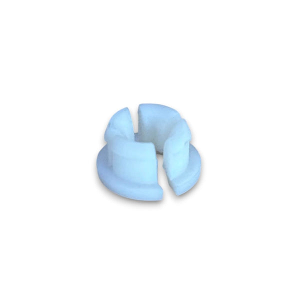 A small white plastic ring-shaped component with a split center, shown on a plain white background.