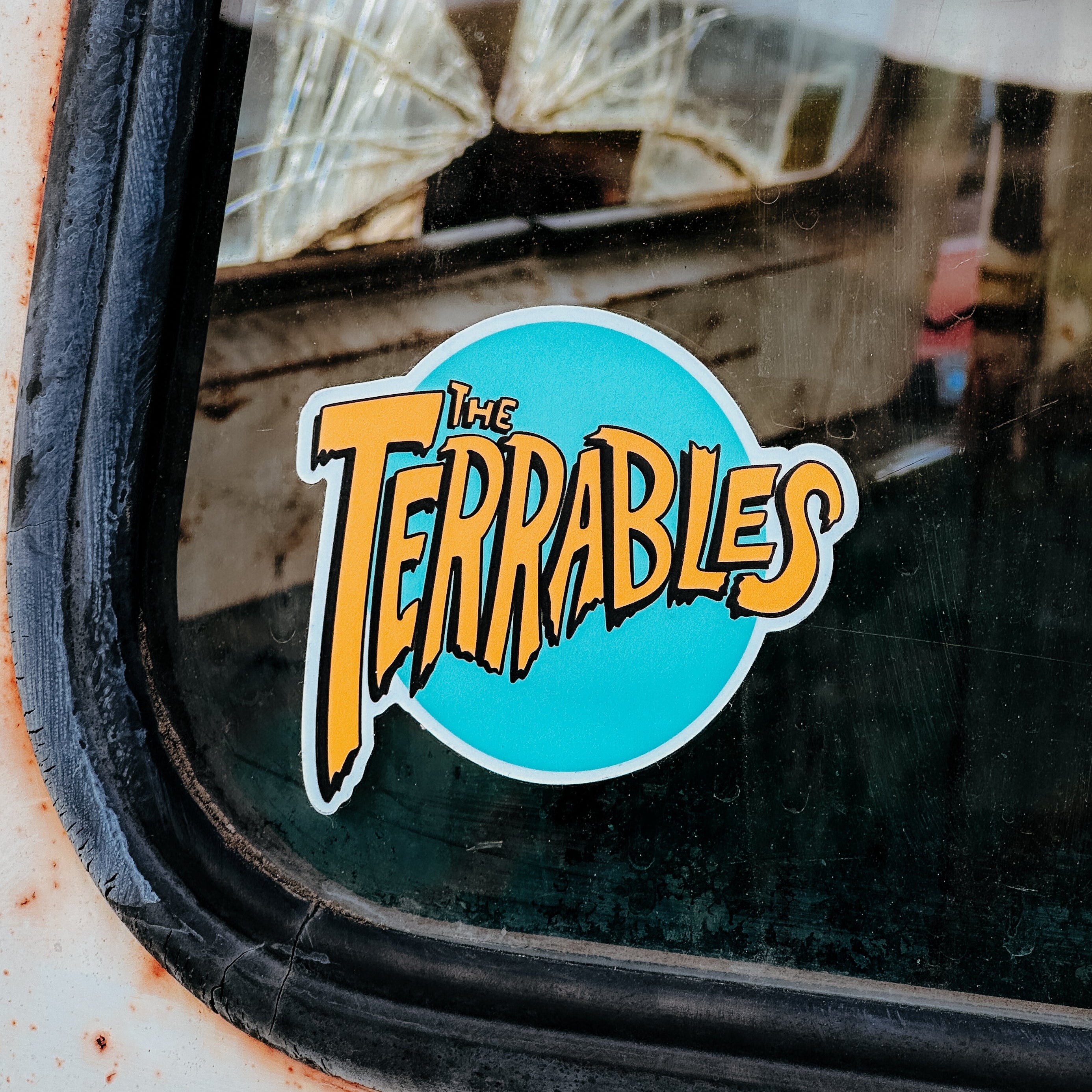 Sticker with 'The Terrables' logo on a vehicle window